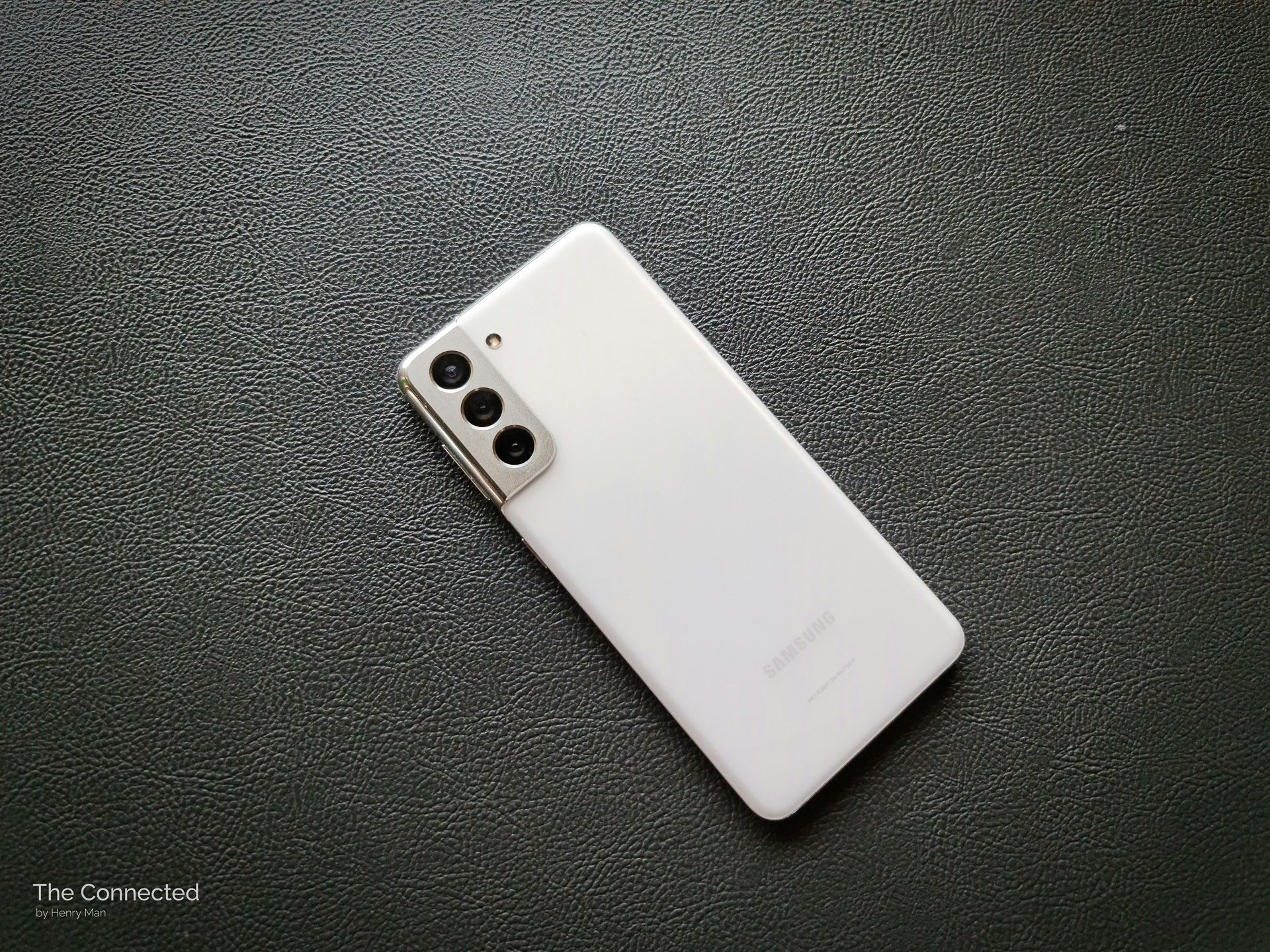 White Samsung Galaxy S21 with black leather background