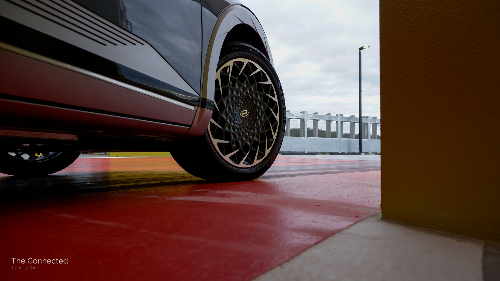 Hyundai Ioniq 5 20-inch alloy wheels turning on red-painted car park floor