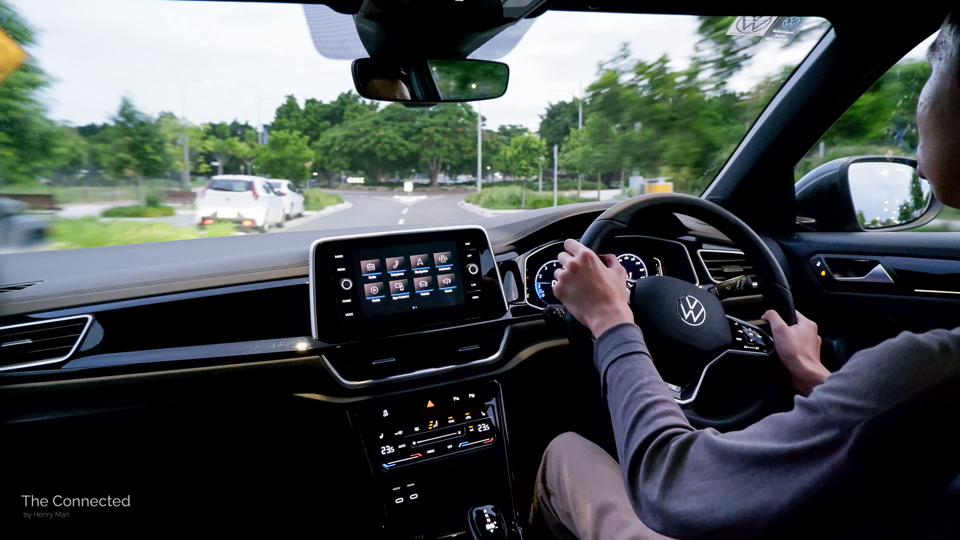 Man driving Volkswagen T-Roc in street at night