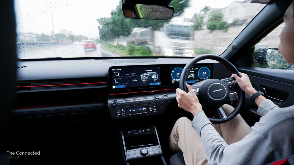 Man driving Hyundai Kona Hybrid N Line in the rain interior view