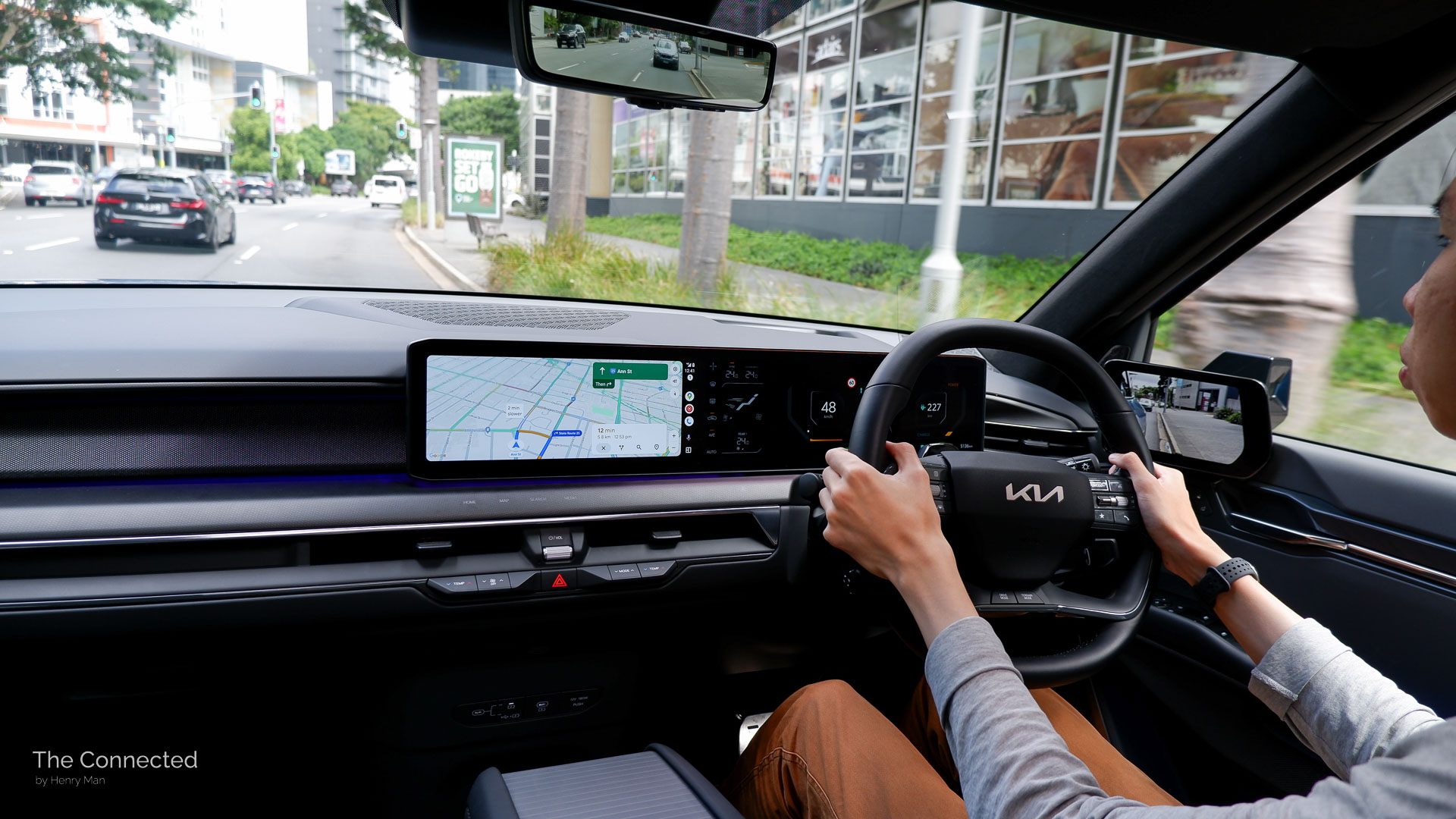 Man driving Kia EV9 in city