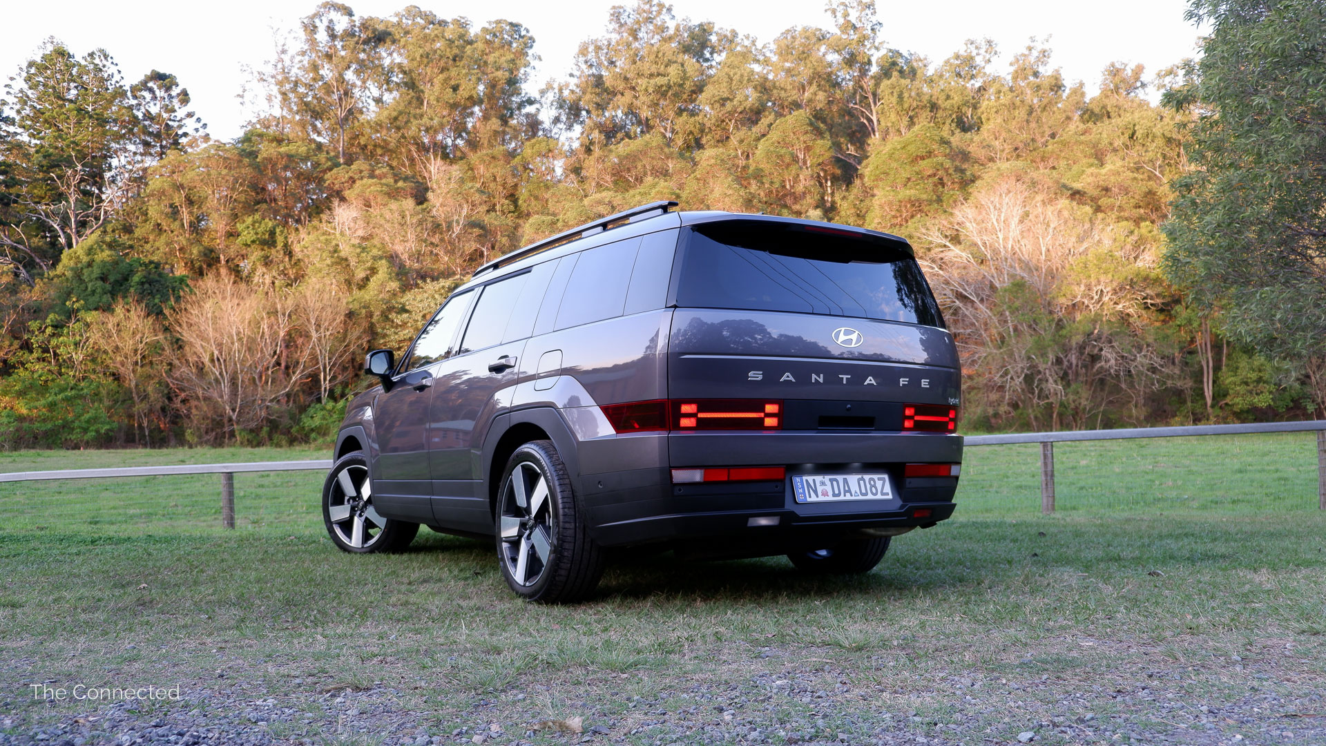 2025 Hyundai Santa Fe Hybrid rear-quarter view in front of forest