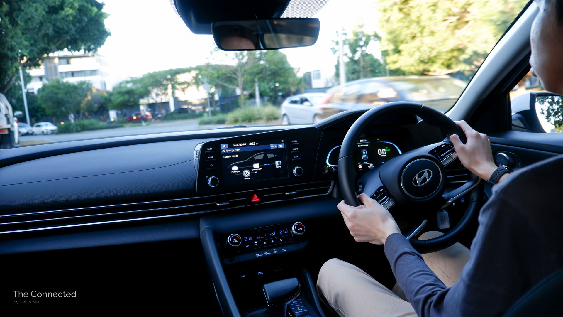 Man driving 2025 Hyundai i30 Sedan through suburban street