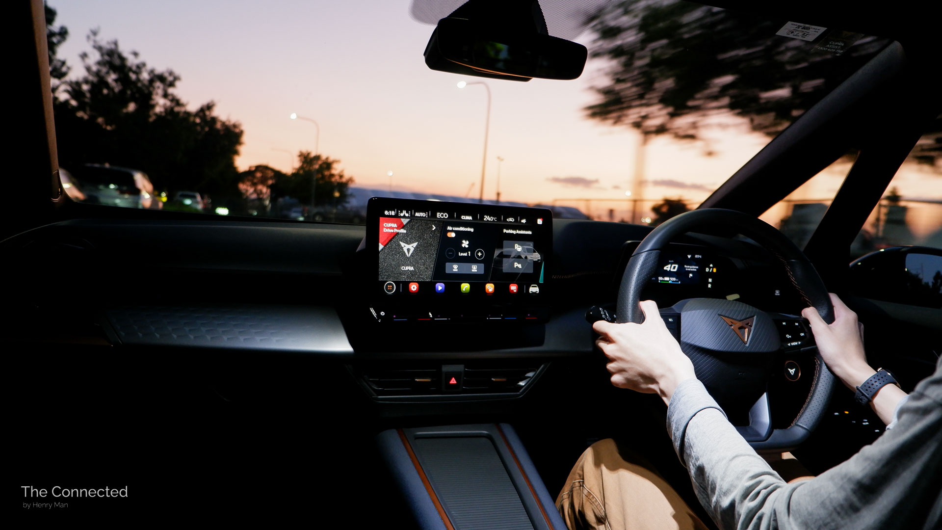 Man driving 2024 Cupra Born in sunset interior view