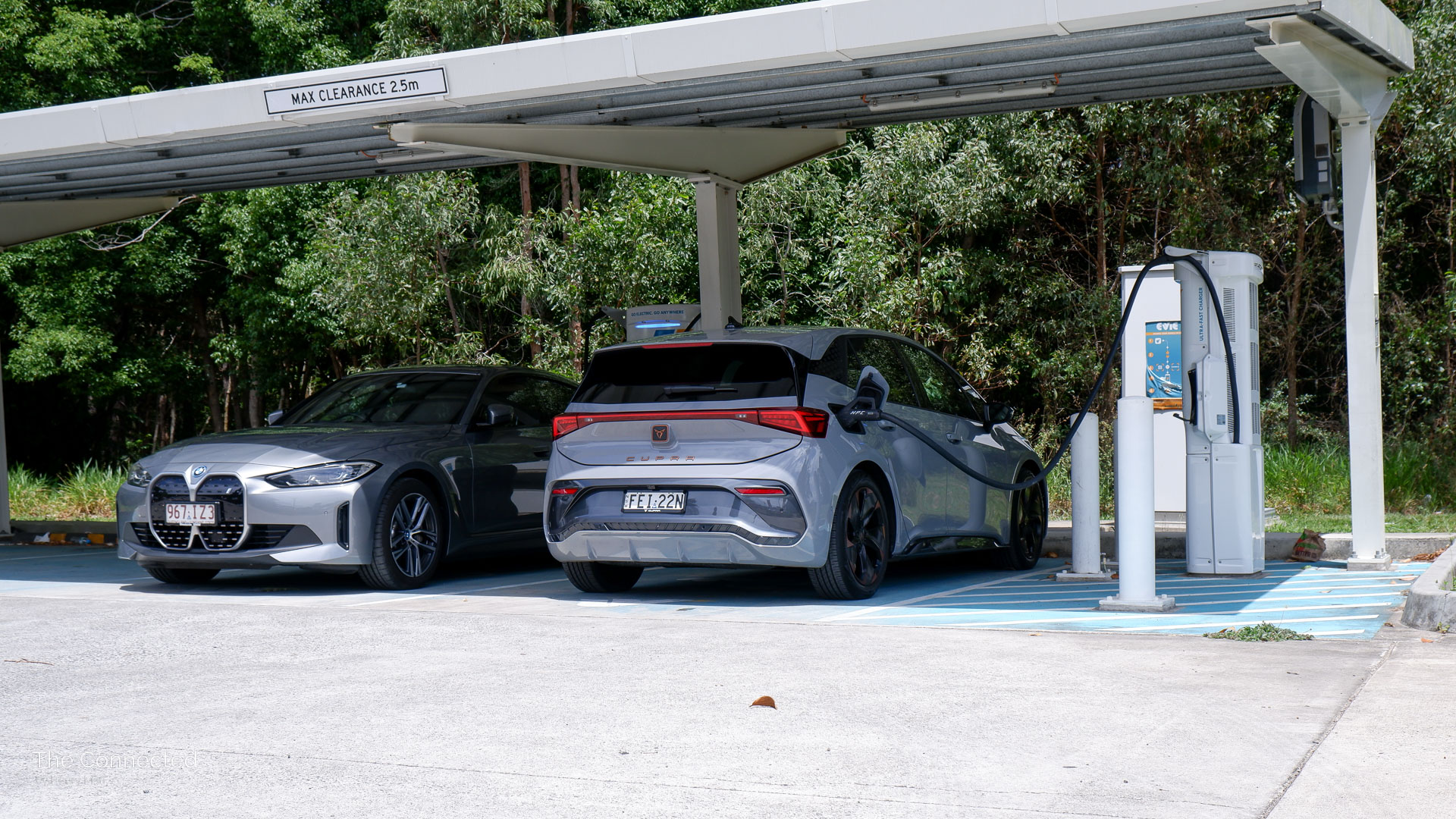 2024 Cupra Born charging next to BMW i4