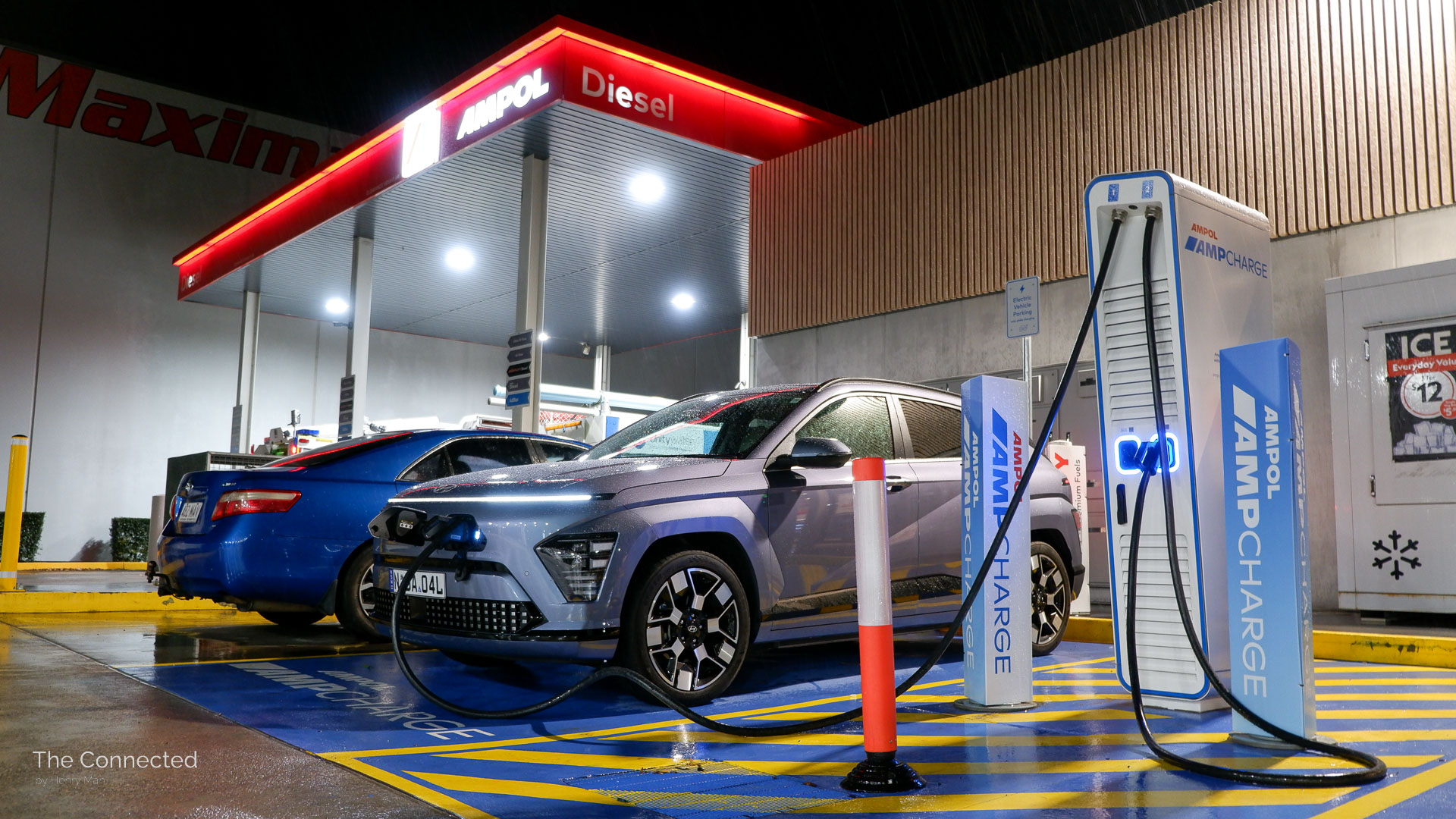 2025 Hyundai Kona Electric Premium charging at Ampol AmpCharge station during the night