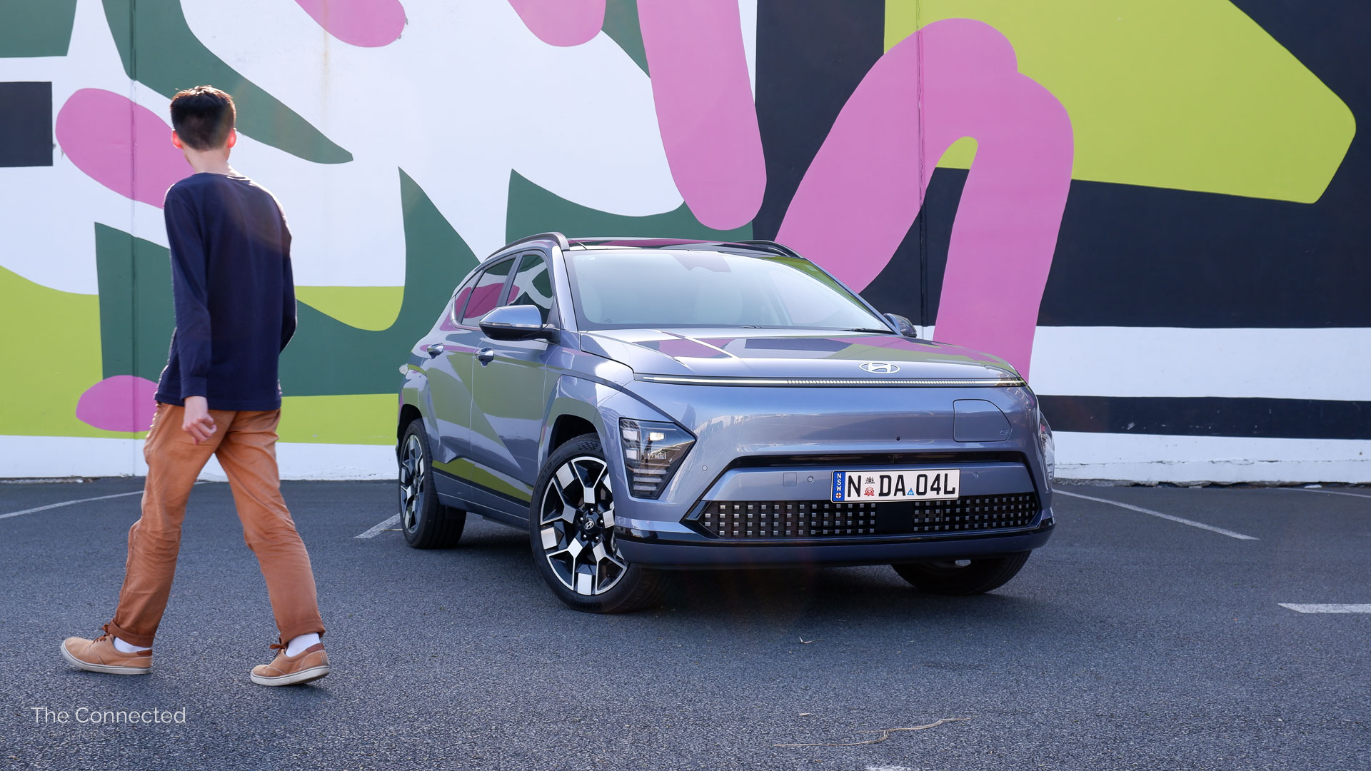 Man walks past 2025 Hyundai Kona Electric Premium