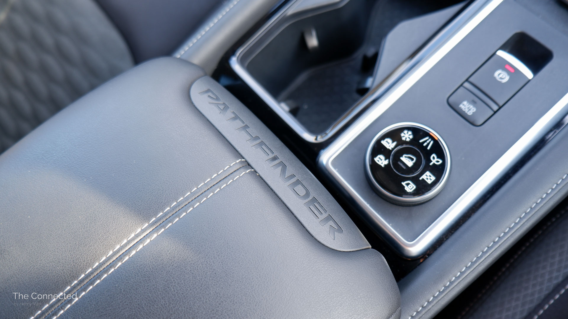 2025 Nissan Pathfinder ST-L AWD interior armrest with 'Pathfinder' logo