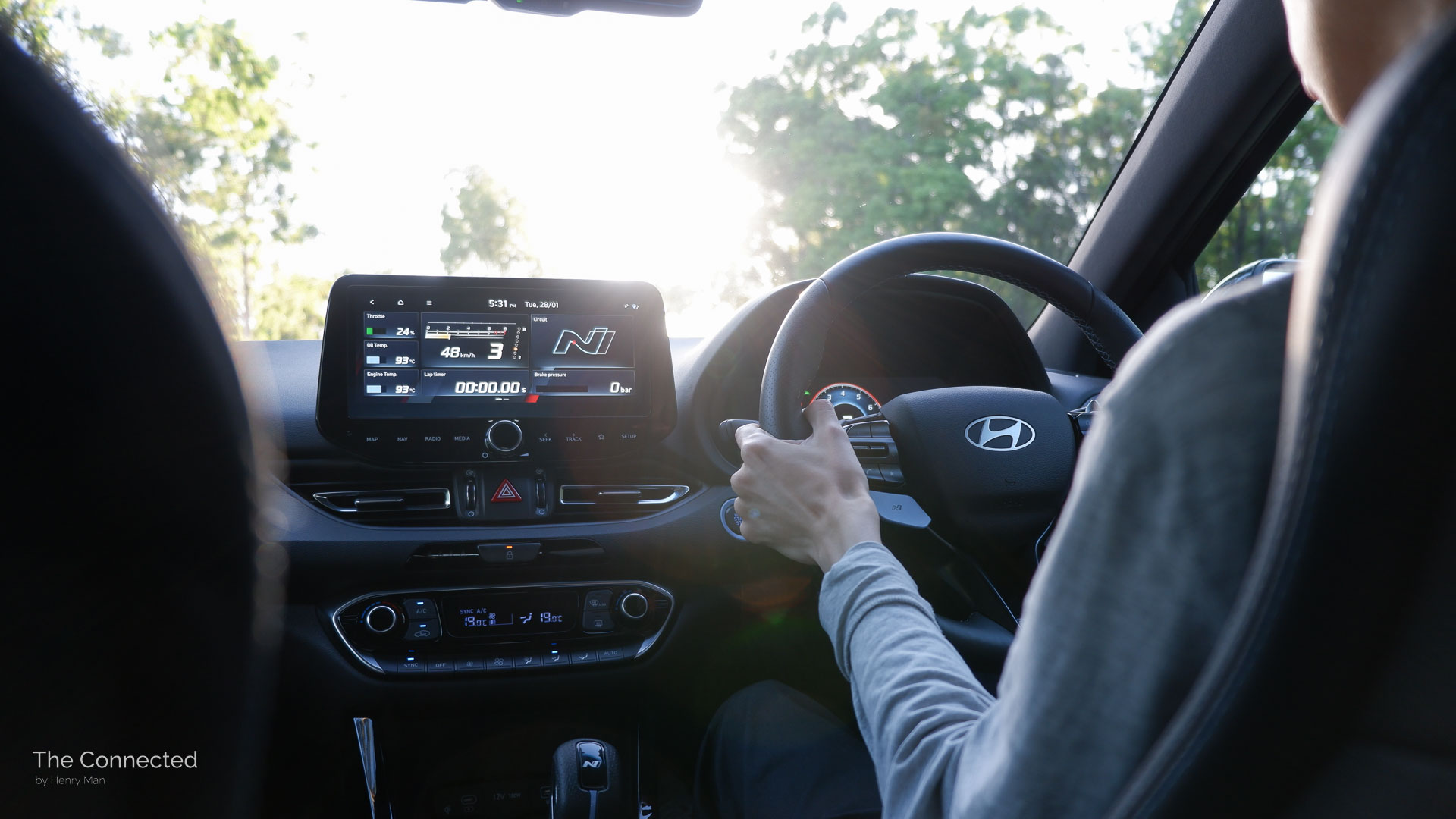 Man driving 2025 Hyundai i30 N in sunset