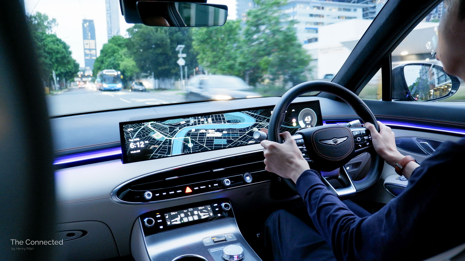 Man driving 2025 Genesis GV70 Signature Sport in the city