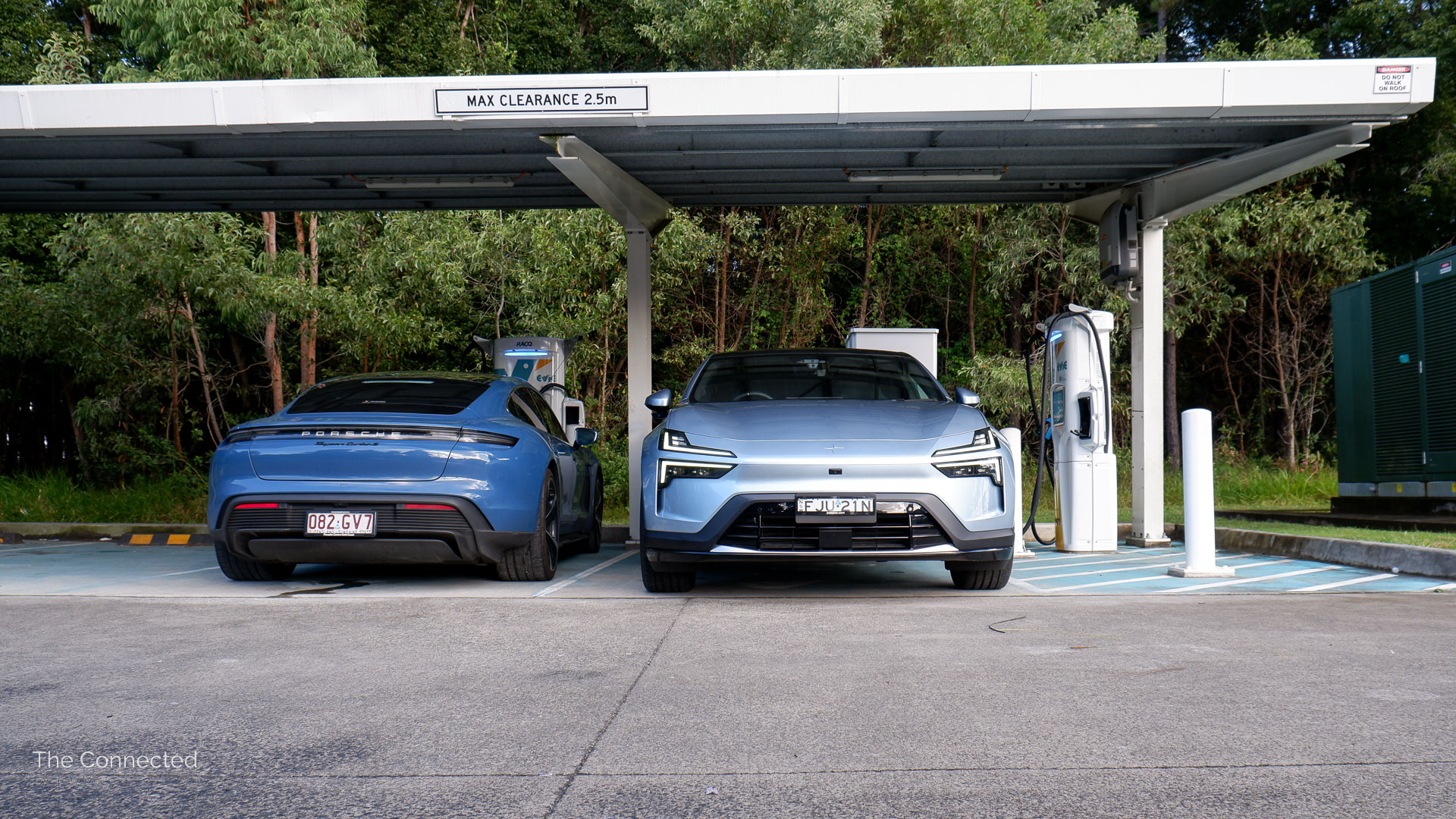 2025 Polestar 4 Long Range Single Motor at fast charging station next to Porsche Taycan Turbo S