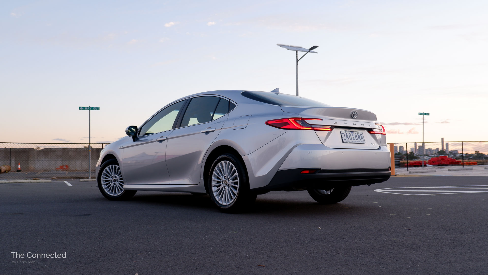 2025 Toyota Camry Ascent Sport rear-quarter view in sunset