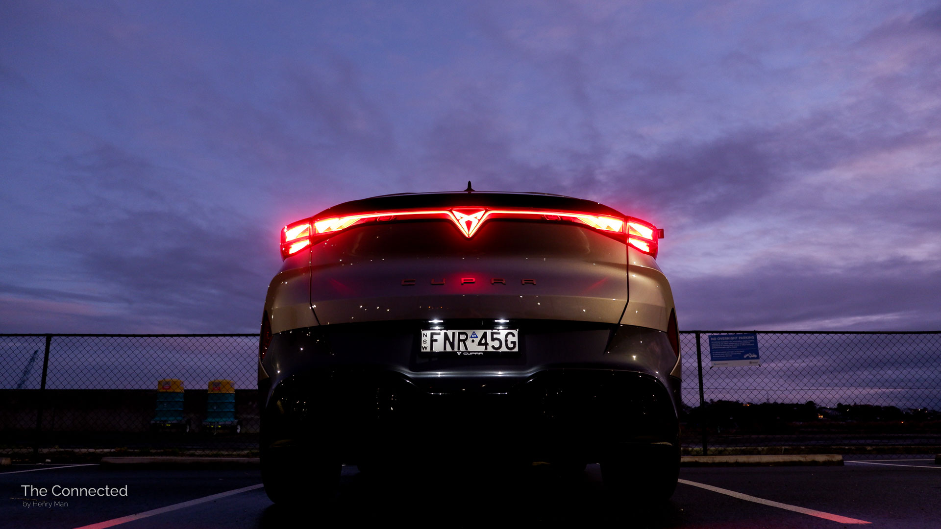 2026 Cupra Tavascan Endurance rear tail-light bar with pink and purple night sky behind