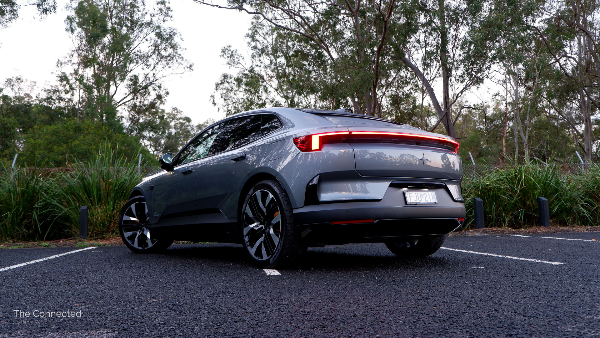 2025 Polestar 4 Long Range Dual Motor with Performance Pack rear-quarter view with forest behind
