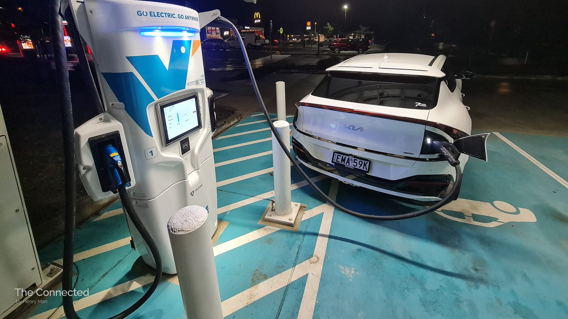 Kia EV6 parked at an angle and plugged-in to public ultra-fast charging station