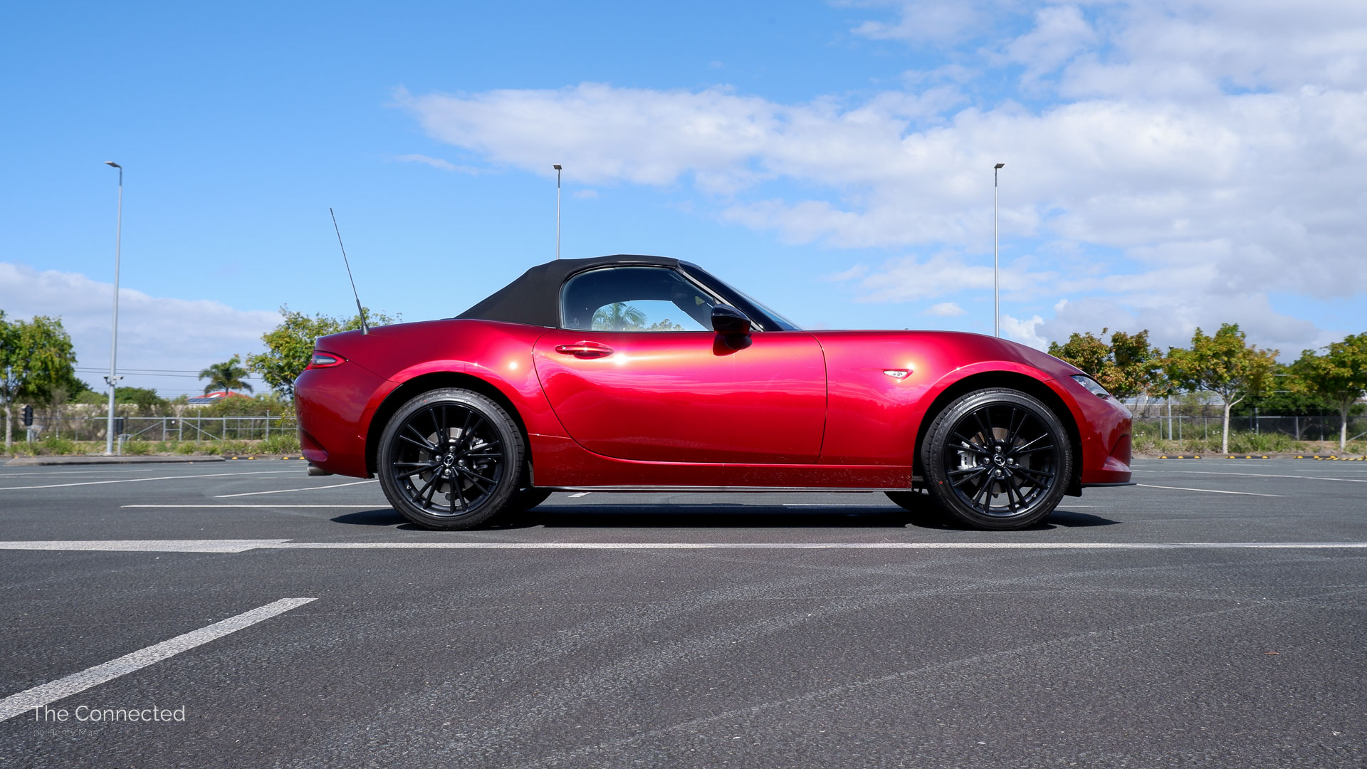 2026 Mazda MX-5 G20 Roadster side view with soft-top roof closed