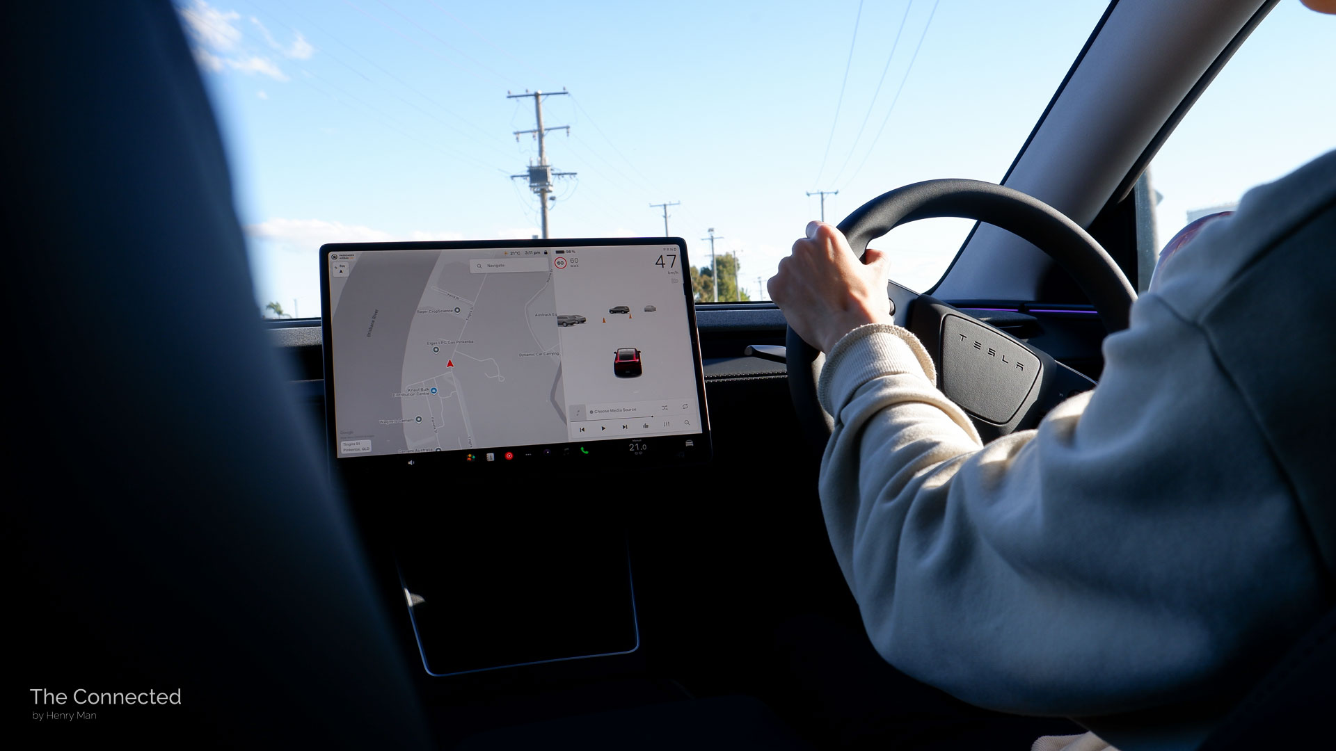 Man driving 2026 Tesla Model Y RWD Ultra Red