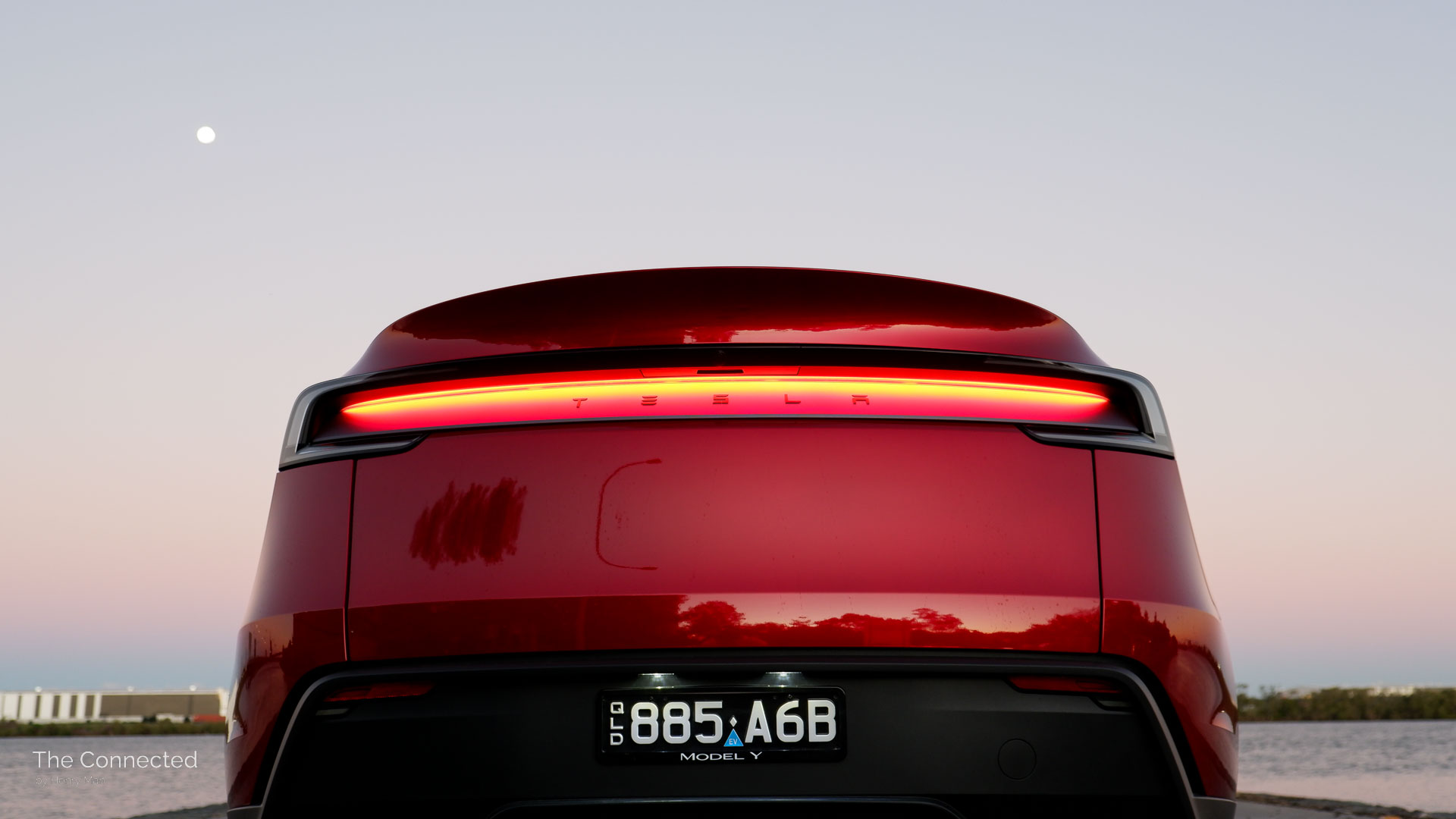 2026 Tesla Model Y RWD Ultra Red rear tail-light bar in the evening