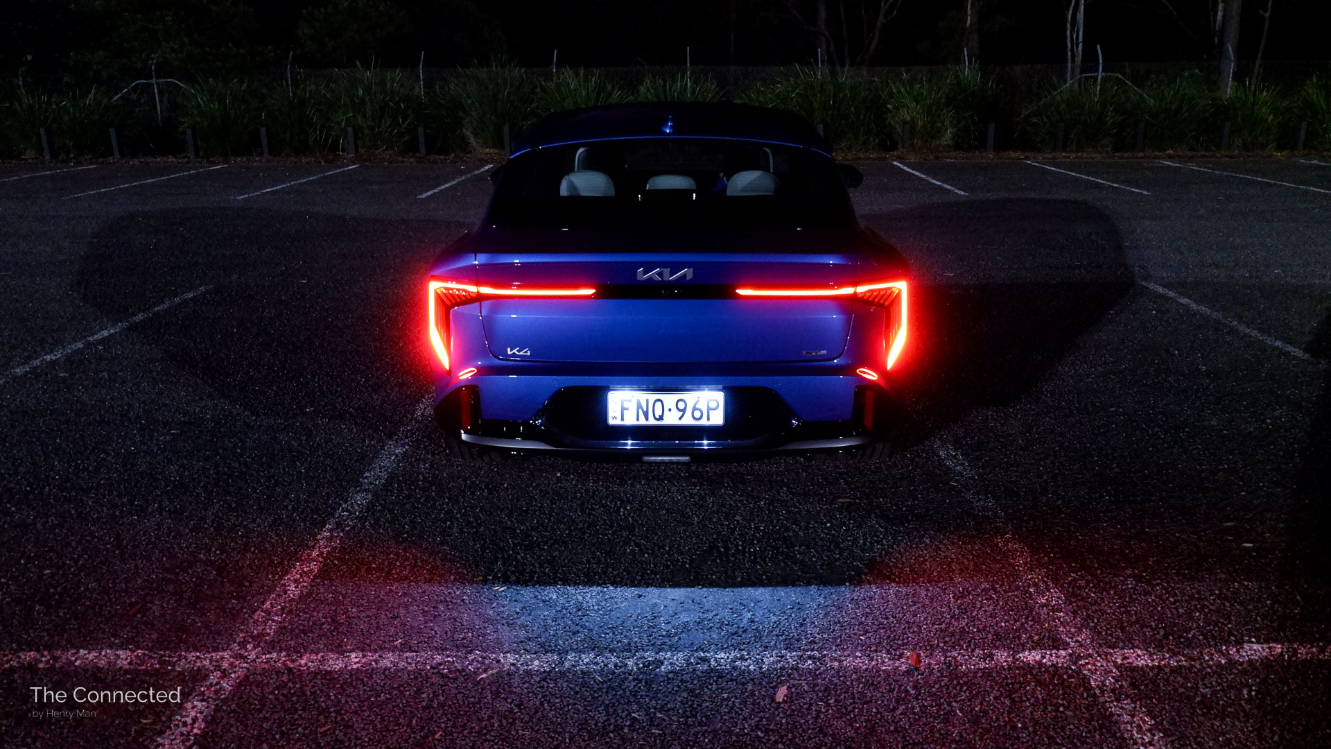 2026 Kia K4 Sedan GT-Line rear LED tail-light shines the ground at night