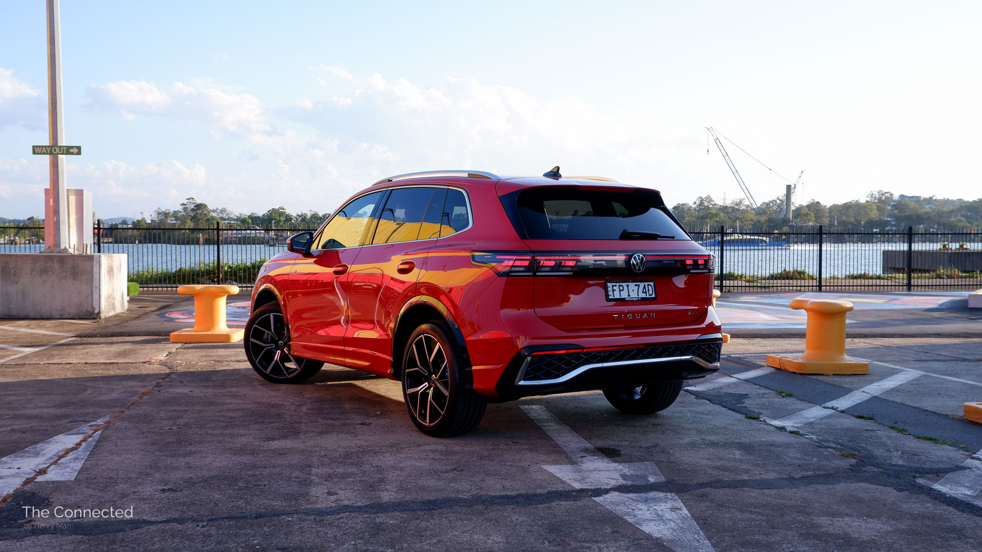 2026 Volkswagen Tiguan 195TSI R-Line rear-quarter view with river and ferry behind