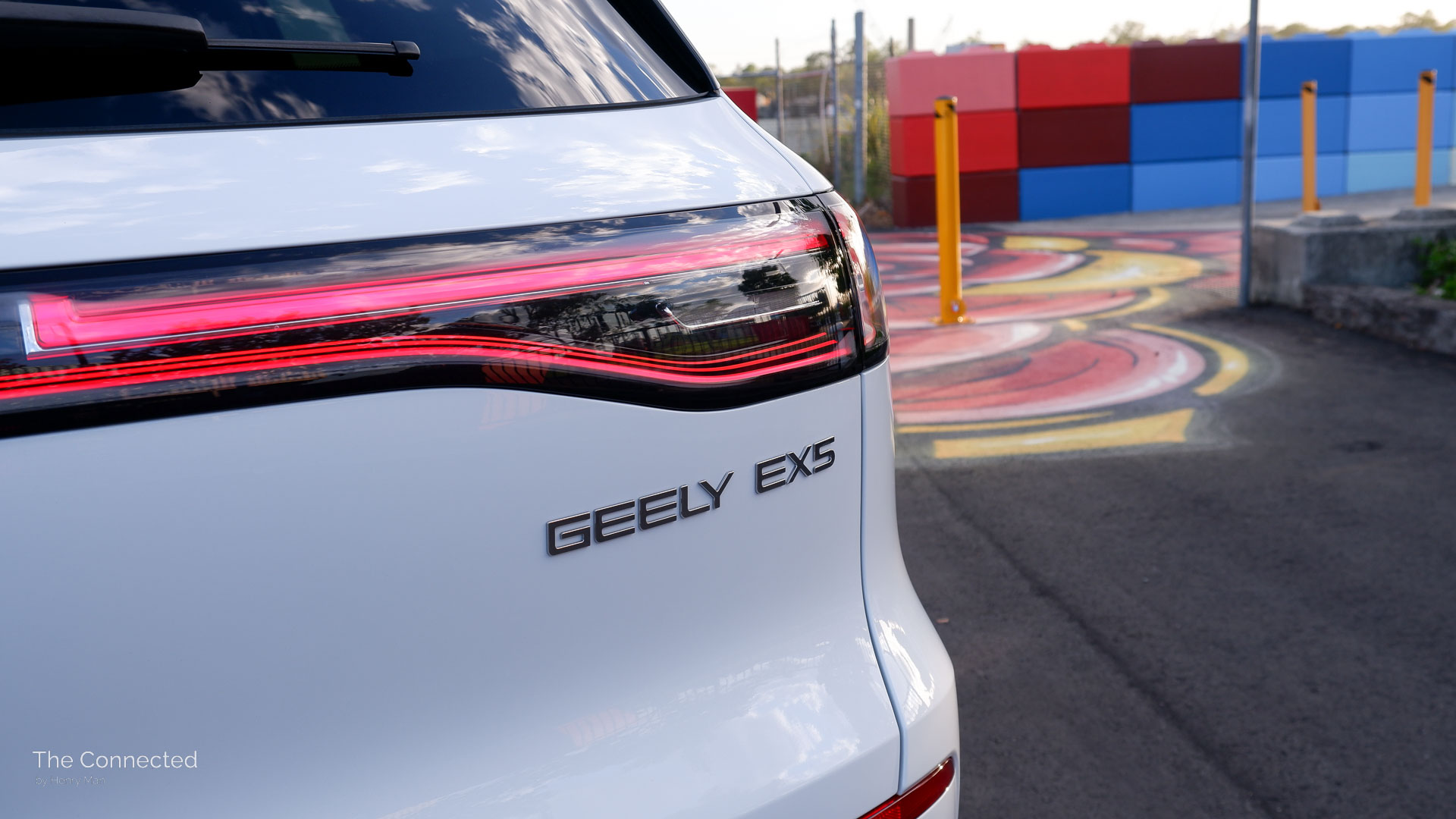 2026 Geely EX5 Inspire rear tail-light and badge with colourful artwork behind