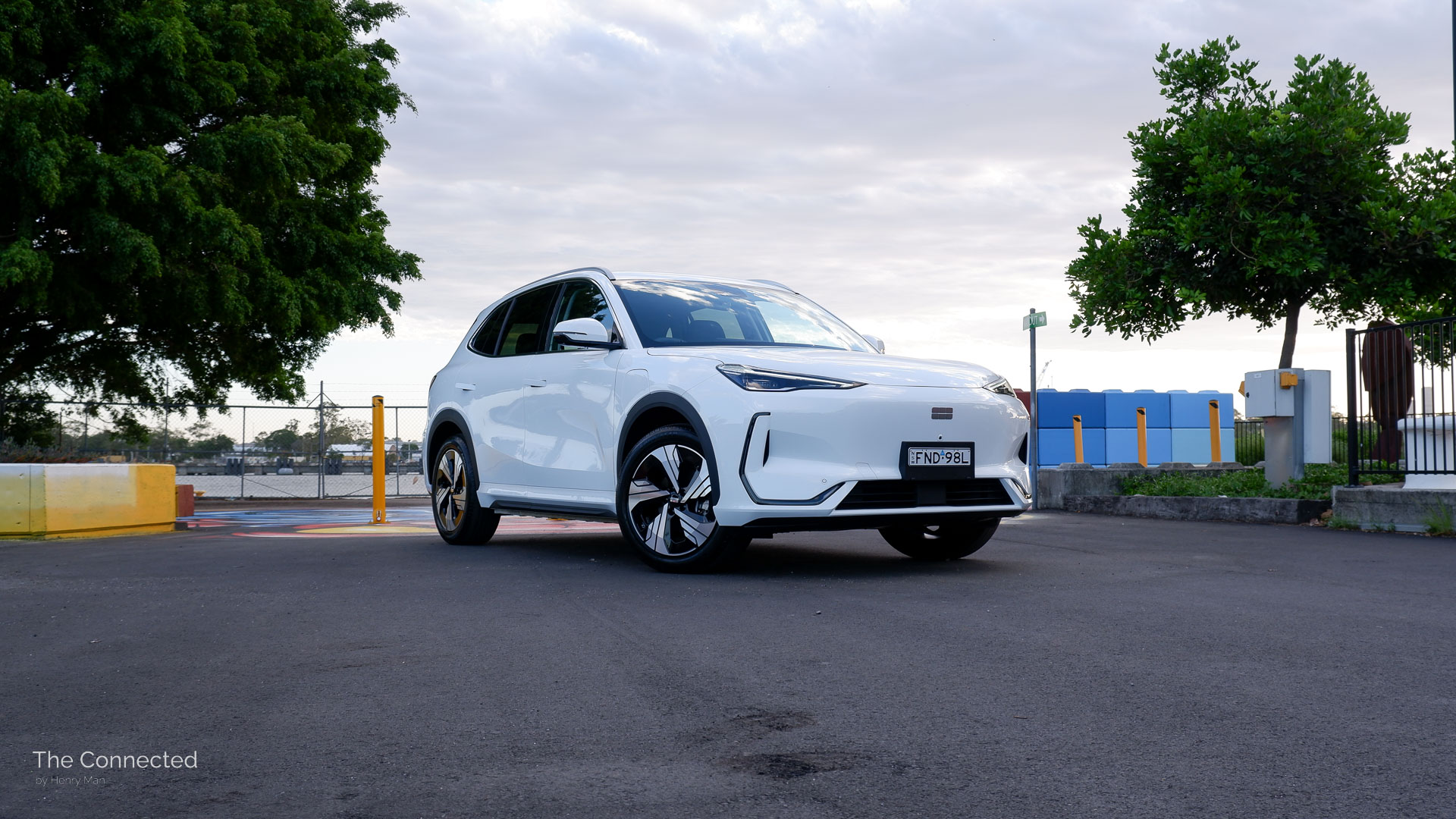 2026 Geely EX5 Inspire front-quarter view with colourful park and tress behind