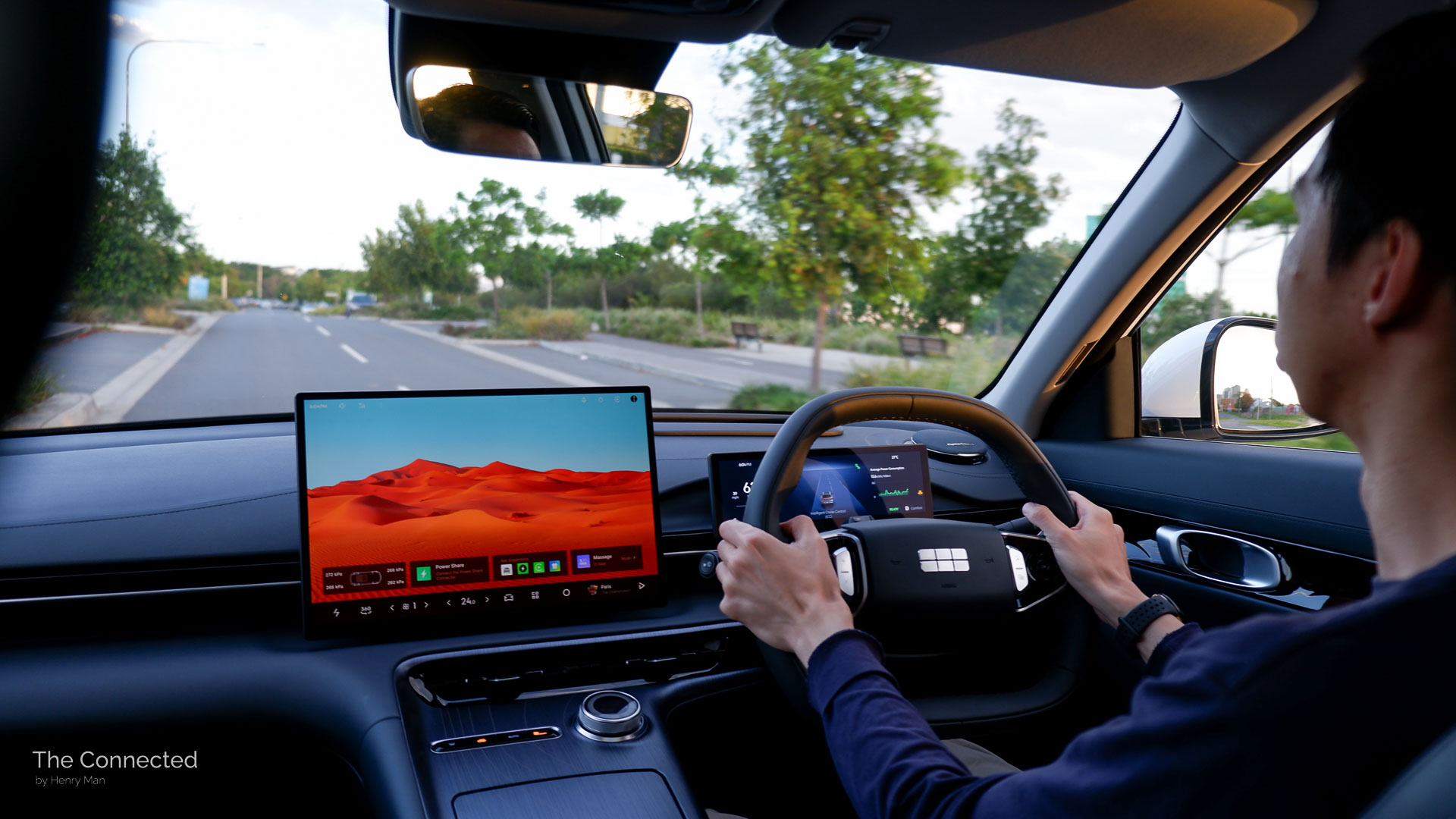 Man driving the 2026 Geely EX5 Inspire through a suburban street