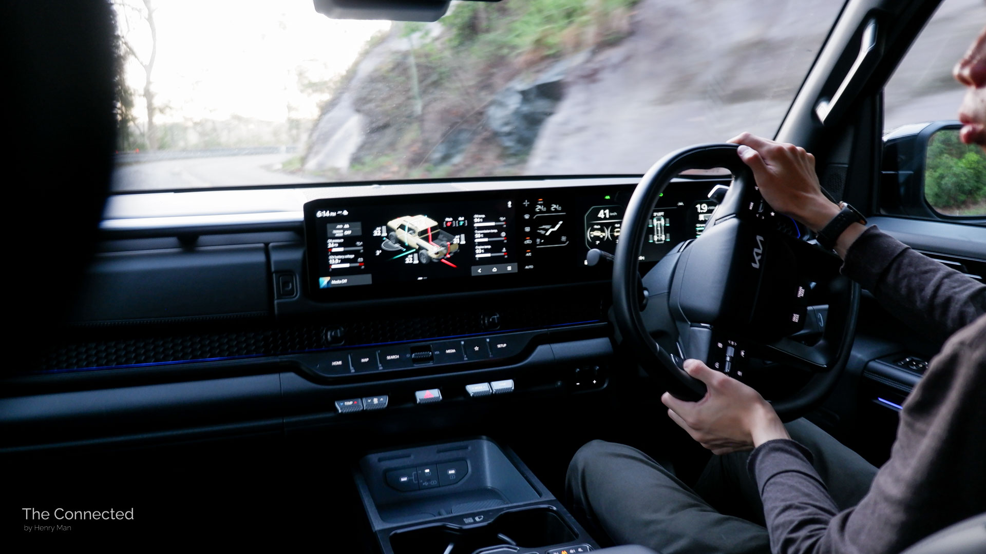 Man driving the 2026 Kia Tasman X-Pro through a forest