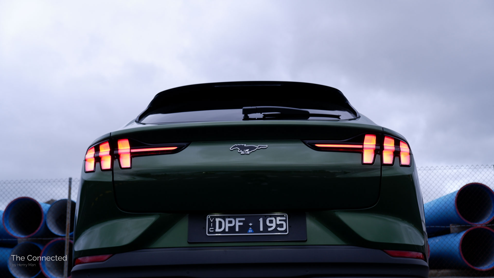 2026 Ford Mustang Mach-E Premium rear tail-lights with cloudy sky behind