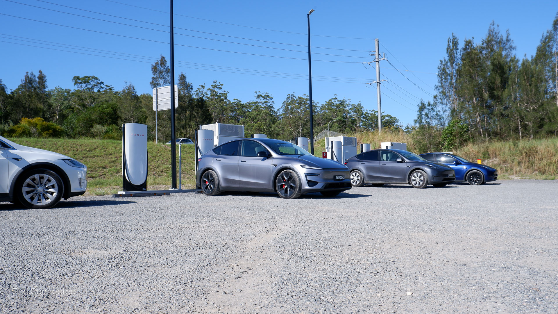 Tesla Model Ys charging at Kew, NSW Tesla Supercharger with Model X on the side