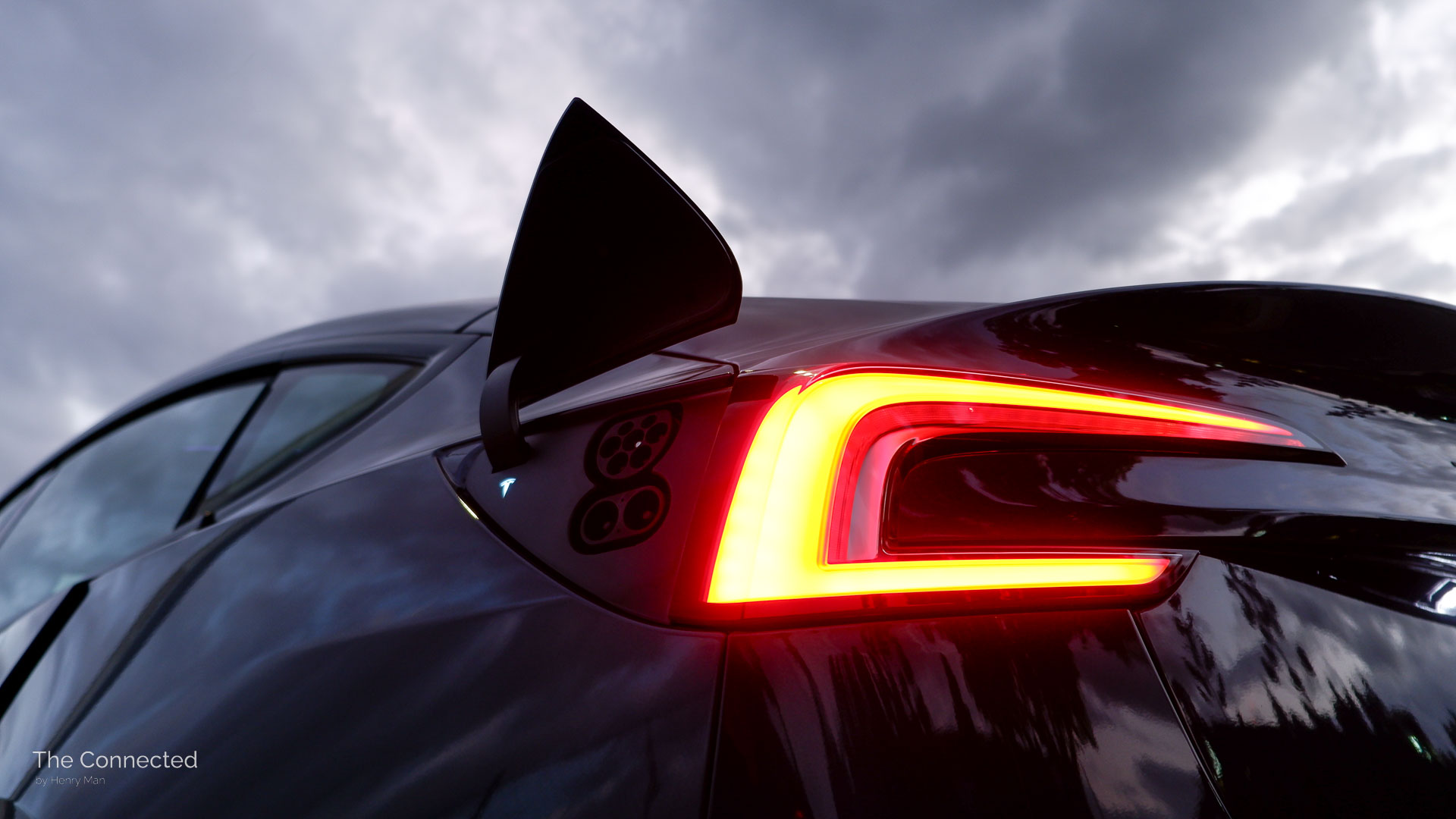 2026 Tesla Model 3 Premium Long Range RWD tail-light with an open charge port lid