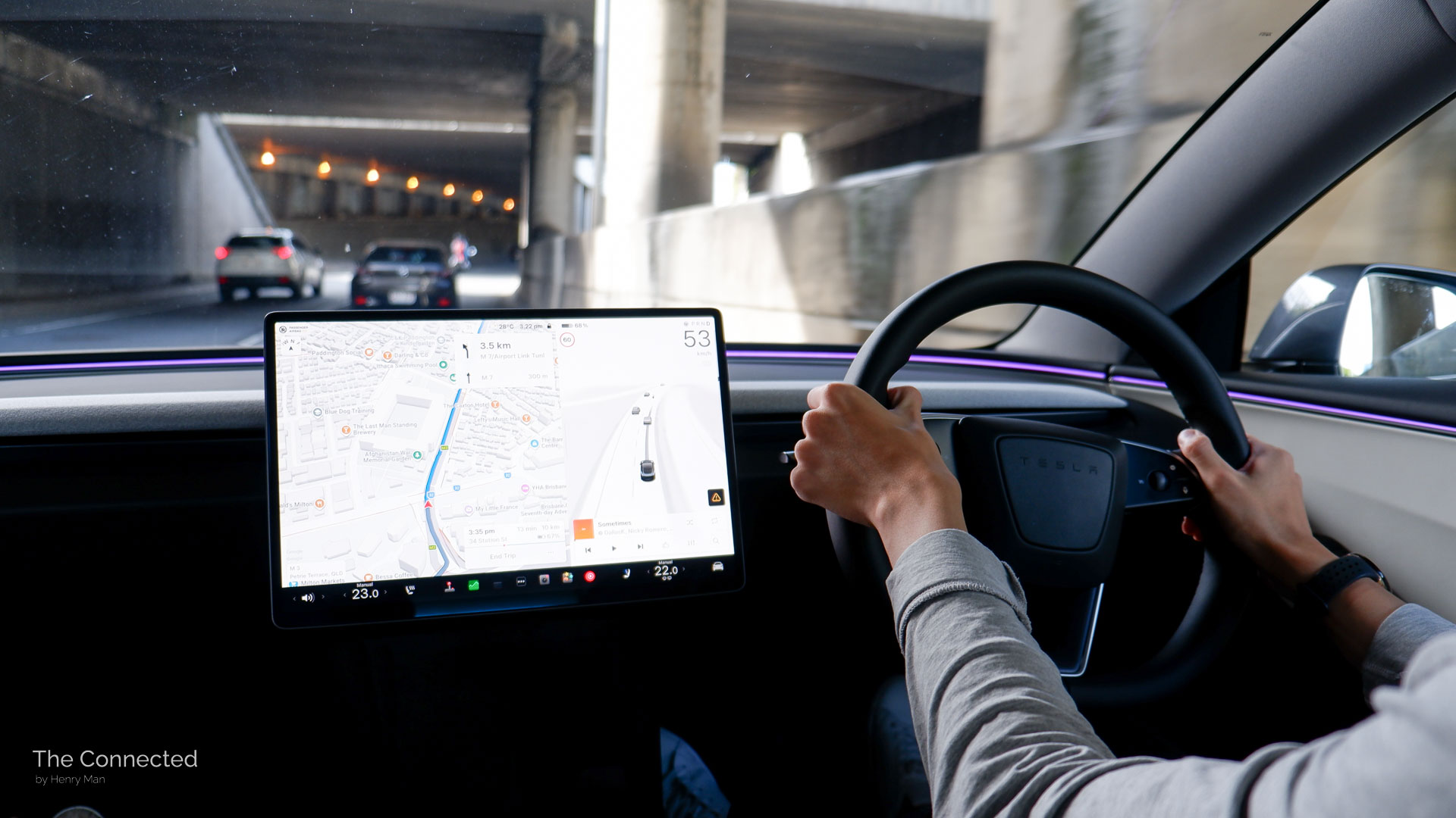 Man driving the 2026 Tesla Model 3 Premium Long Range RWD through an underpass