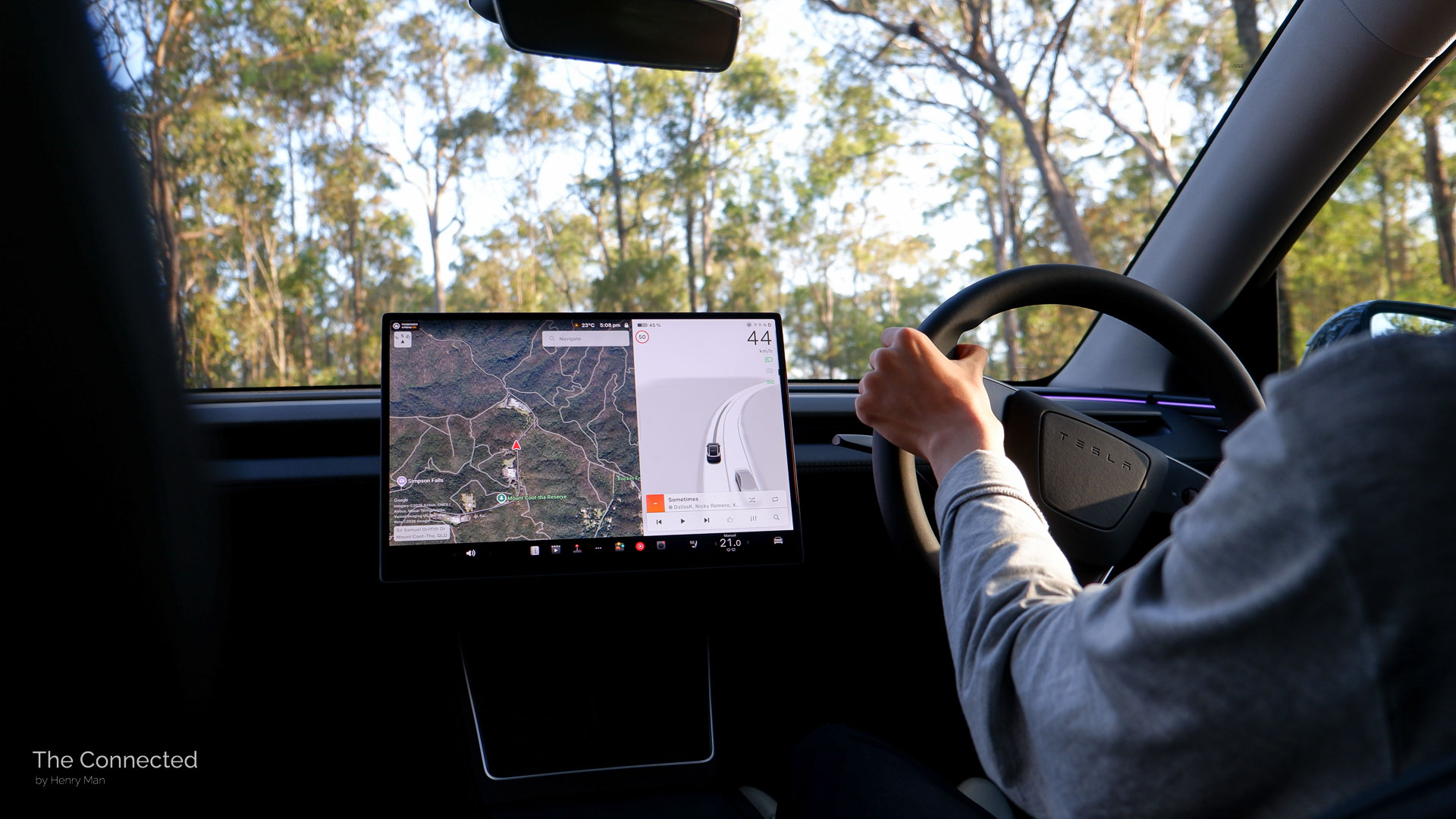 Man driving the 2026 Tesla Model Y Performance AWD through a mountain road