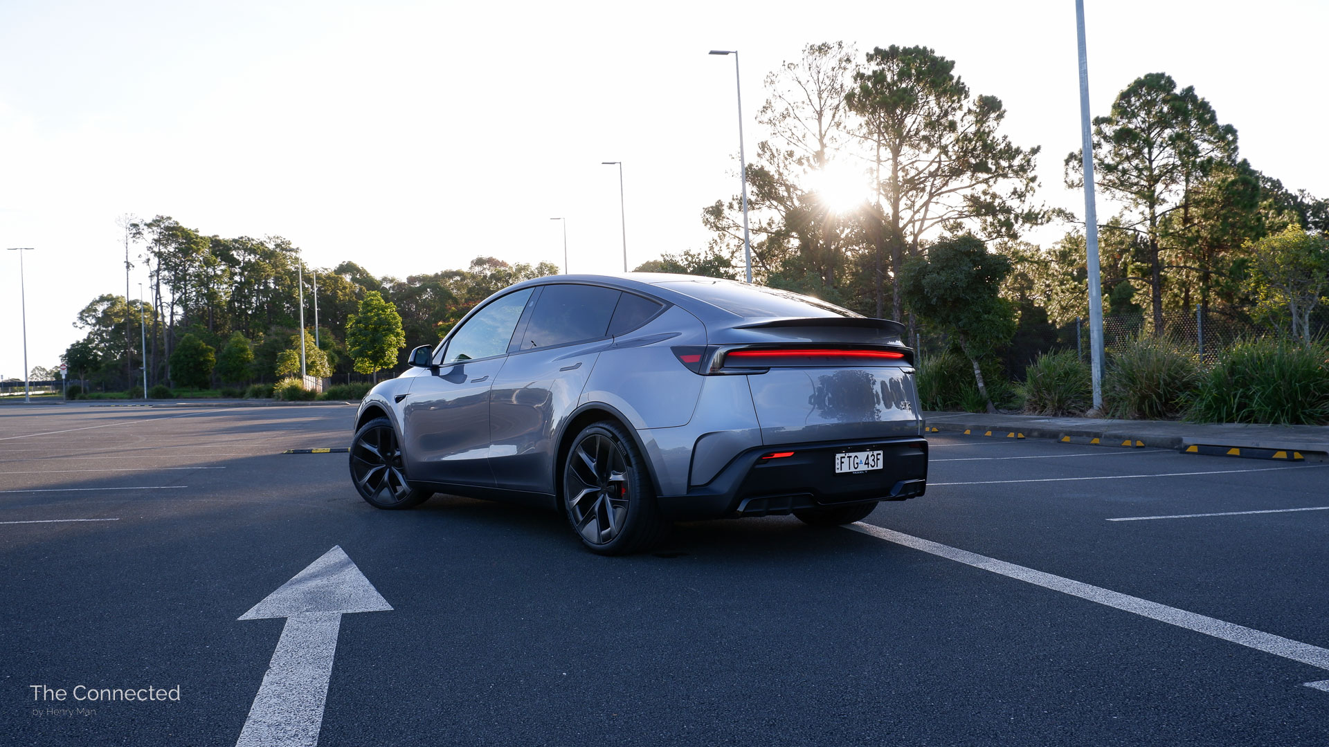 2026 Tesla Model Y Performance AWD rear-quarter view in a car park during the evening